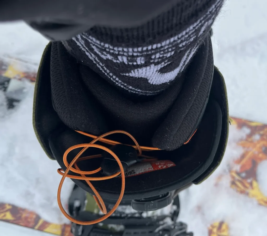 ThirtyTwo Shifty snowboard boot on the back leg with the tongue centered and not sliding to the side, shown from above on a snowy slope.