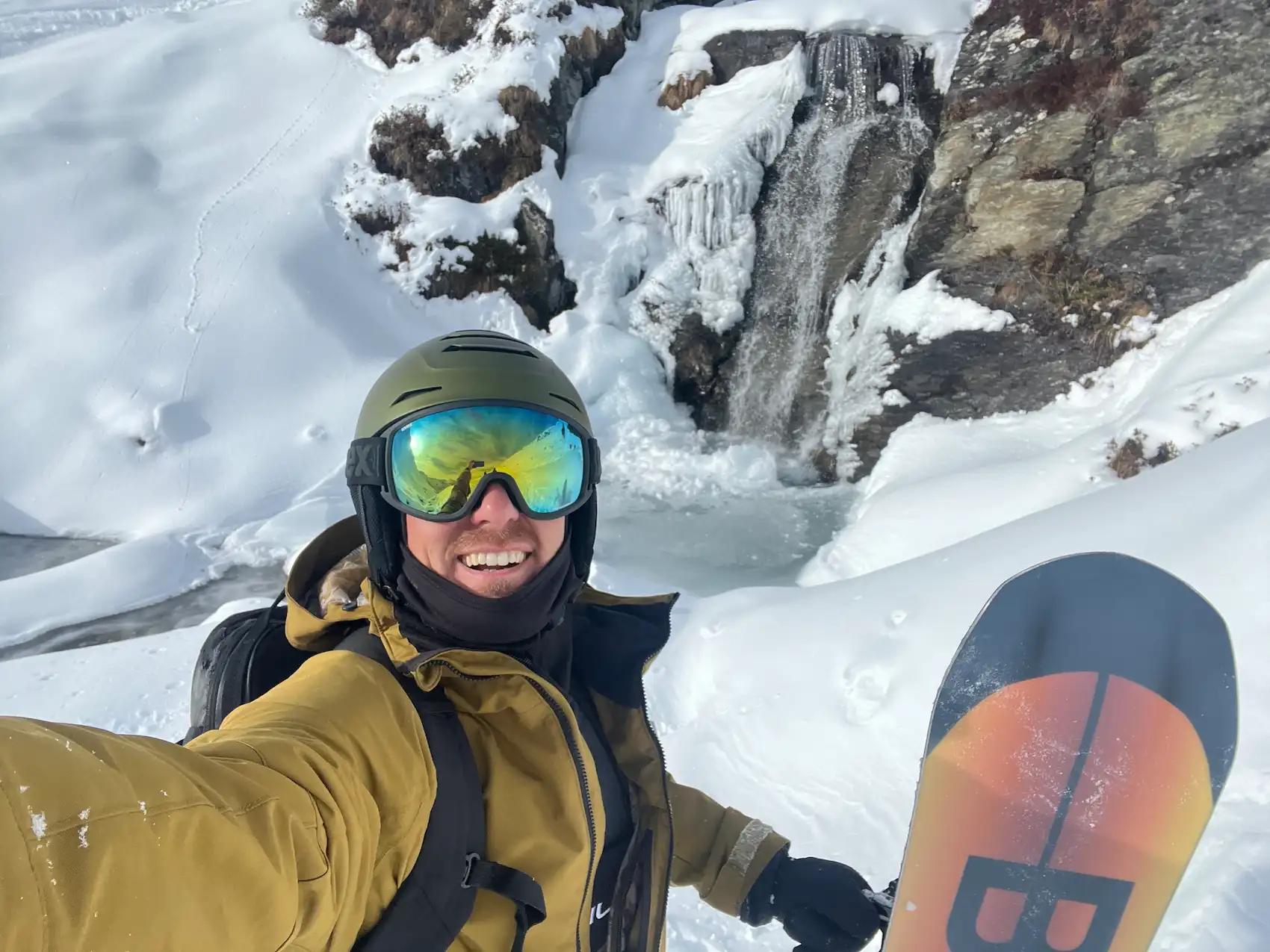 me with my bataleon funkink snowboard standing next to a mini waterfall on some freeride spot we found in Ischgl, Austria.