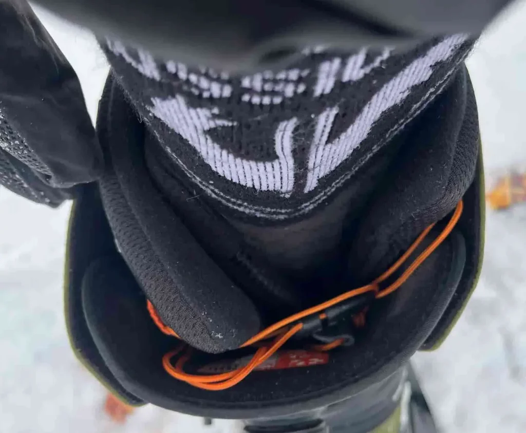 Front foot ThirtyTwo Shifty snowboard boot with the tongue shifted to the side and sliding out of place, shown from above on snow.